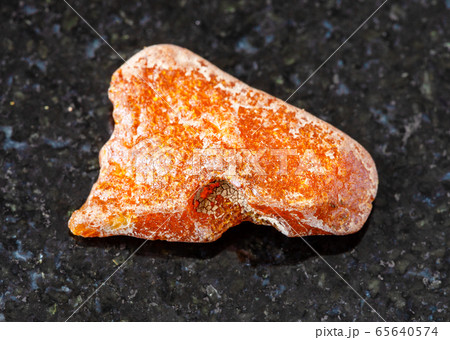 unpolished Amber gemstone on black 65640574