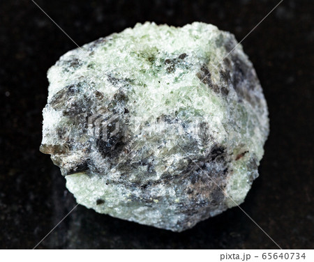 unpolished saccharoidal Apatite rock on black 65640734