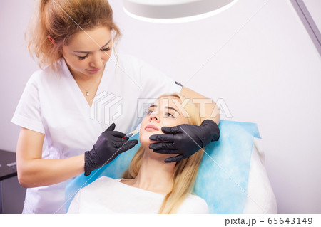 Lip Augmentation In Cosmetology Clinic. Beautiful Woman Getting Beauty Injection For Lips 65643149
