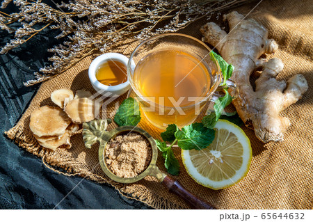 Hot Ginger juice with lemon and mint, root and 65644632