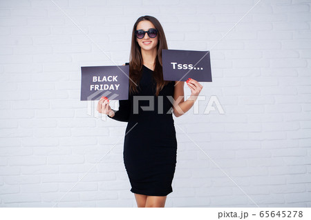 Black Friday. Woman with the inscription Black Friday and gift bags on a white background Black Friday. Woman with the inscription Black Friday and gift bags on a white background 65645278