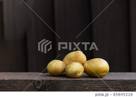 Fresh organic potatoes on the wooden table, copy space, dark background 65645319