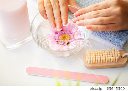 Nails care. Beautiful woman's nails with french manicure, in beauty studio 65645500