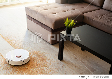 Robot vacuum cleaner performs automatic cleaning of the apartment at a certain time. Smart home. 65645566
