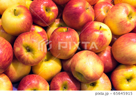 Red ripe and yellow apple background Red ripe and yellow apple background 65645915