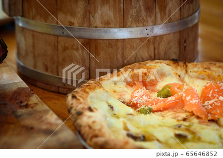 Homemade pizza with capers on a wood table Homemade pizza with capers on a wood table 65646852