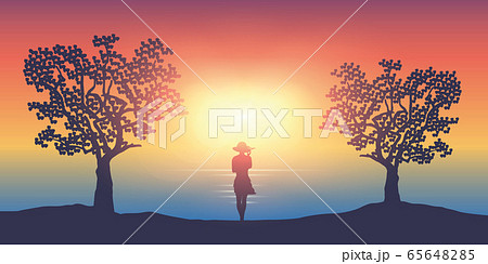 summer girl on a sunny day stands between two trees by the ocean summer girl on a sunny day stands between two trees by the ocean 65648285