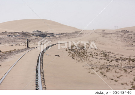 Abandoned and forgotten railway being taken over by encroaching sandstorm, Kolmanskop ghost town, Namib Desert. Africa 65648446