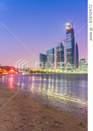 Night view of a beach and high rise buildings 65650472