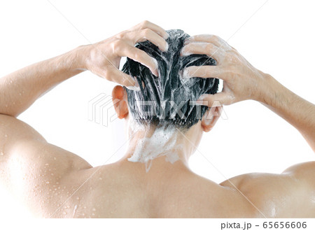 Closeup young man washing hair with shampoo 65656606
