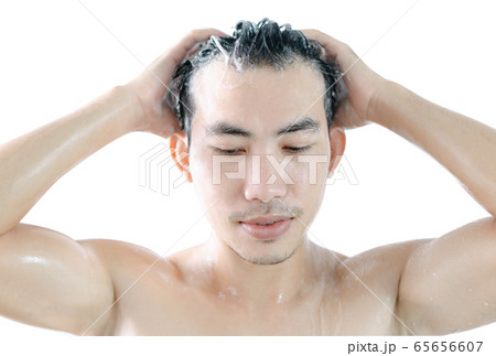 Closeup young man washing hair with shampoo Closeup young man washing hair with shampoo 65656607