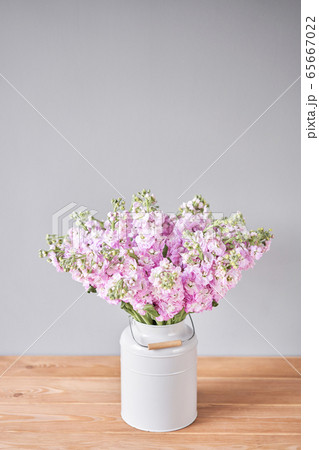 Bouquet of Beautiful lilac mattiola. Spring flowers in vase on wooden table. Flowers delivery. 65667022