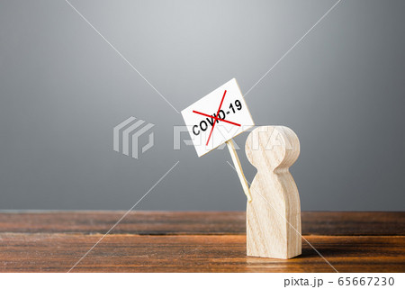 A person with a poster protests against quarantine measures. Conspiracy theories followers. Denial of the existence of the virus. The result of a hybrid information war and the manipulation of facts. 65667230