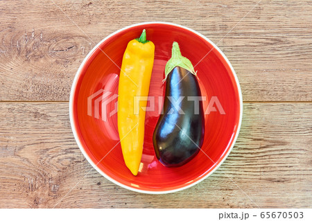 pod of yellow pepper and almost black eggplant on 65670503