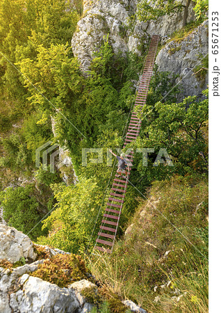 Man Walking on Via Ferrata Trail Man Walking on Via Ferrata Trail 65671253