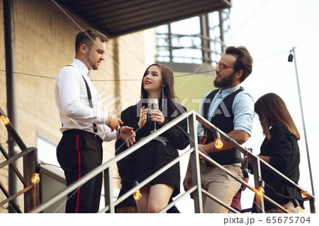 Group of young caucasian people celebrating, look happy, have corporate party at office or bar Group of young caucasian people celebrating, look happy, have corporate party at office or bar 65675704