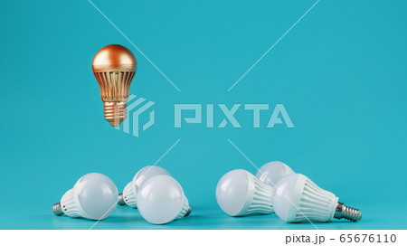 A prominent gold light bulb levitates above an 65676110