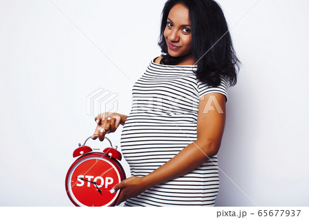 young pretty african american woman pregnant happy smiling, posing on white background isolated , lifestyle people concept copyspace young pretty african american woman pregnant happy smiling, posing on white background isolated , lifestyle people concept copyspace 65677937