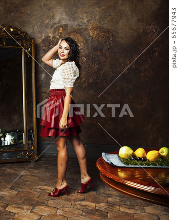 young pretty rich italian woman in golden luxury room interior, elegant styled hotel, people on vacation 65677943