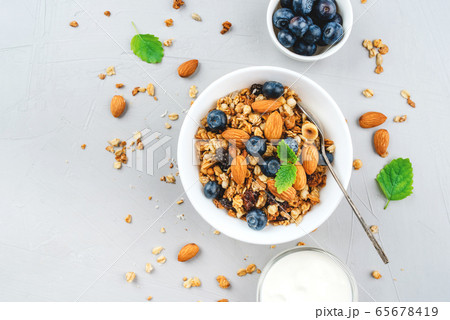 Baked granola with yogurt and blueberries. 65678419