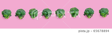 Fresh green broccoli on pink background Fresh green broccoli on pink background 65678894