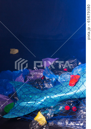 Close-up of fantasy mermaid in deep ocean sad because water pollution.  Plastic trash and bottles pollution in ocean. Ecocatastrophe, garbage and  plastic recycling concept., Stock image