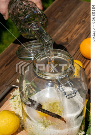 Pour the vodka into the big jar with the Pour the vodka into the big jar with the 65680184