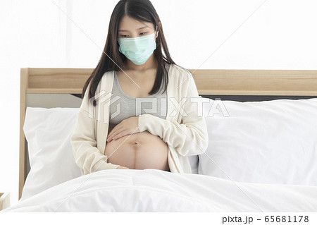 Young Asain woman coughing for effective caused of cold or influenza, wearing mask cover her face. 65681178