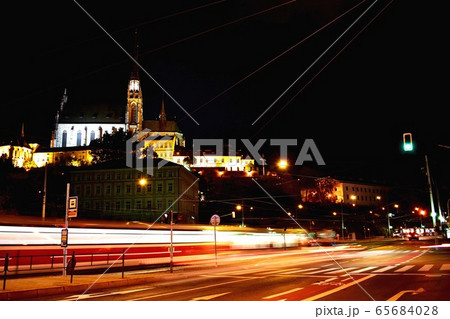 A traffic light on a city street at night A traffic light on a city street at night 65684028
