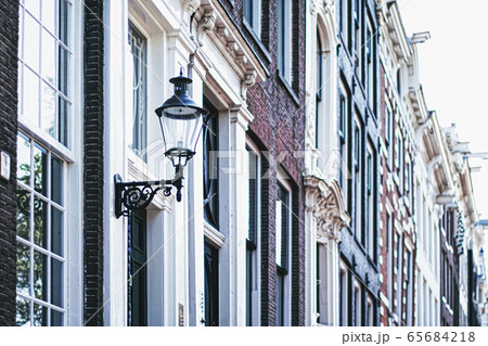 Architectural detail of a building on the main city center street of Amsterdam in Netherlands Architectural detail of a building on the main city center street of Amsterdam in Netherlands 65684218