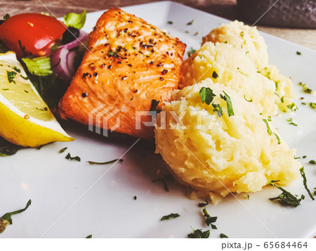 Grilled salmon, mashed potatoes and salad for lunch Grilled salmon, mashed potatoes and salad for lunch 65684464