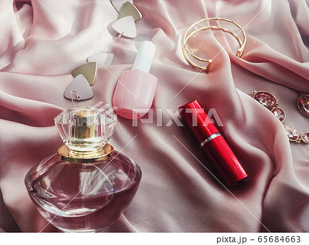 Fashionable and stylish accessories, jewelry and make-up products on pink silk background, beauty and fashion 65684663