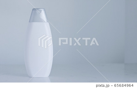 Blank label cosmetic container bottle as product mockup on gray background 65684964