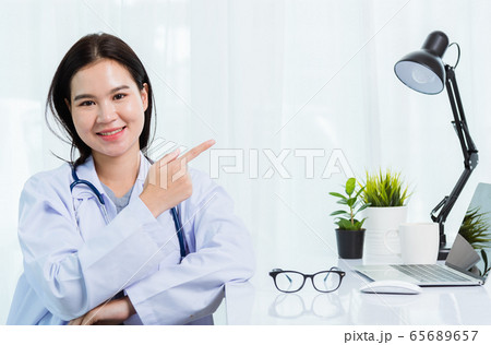 Asian female doctor working personal laptop 65689657