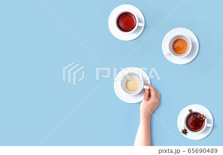 Female hand holding a tea cup Female hand holding a tea cup 65690489