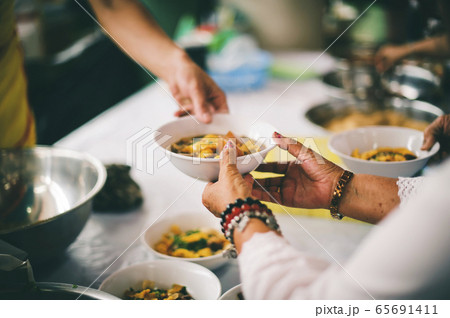 Feeding the poor to hands of a beggar, Poverty Feeding the poor to hands of a beggar, Poverty 65691411