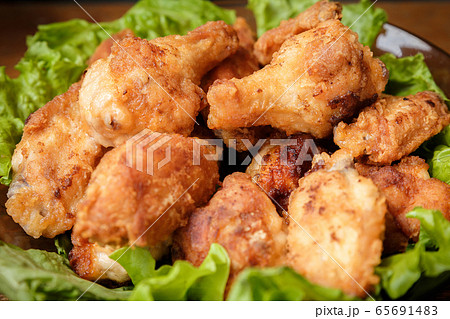 Fried chicken shins in a crispy crust on lettuce 65691483