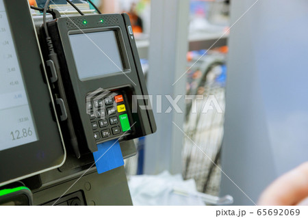 Close up of moment of payment by credit card into Close up of moment of payment by credit card into 65692069