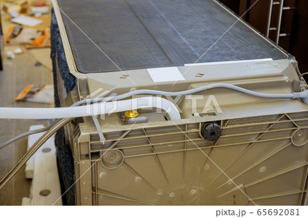 Plumber connected the dishwasher in the kitchen Plumber connected the dishwasher in the kitchen 65692081