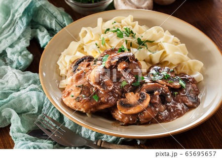 Delicious chicken marsala served with fettucine 65695657