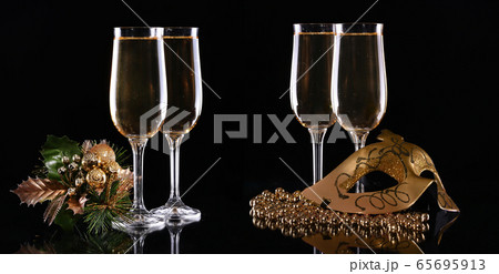 Carnival mask and glasses with champagne on a dark Carnival mask and glasses with champagne on a dark 65695913