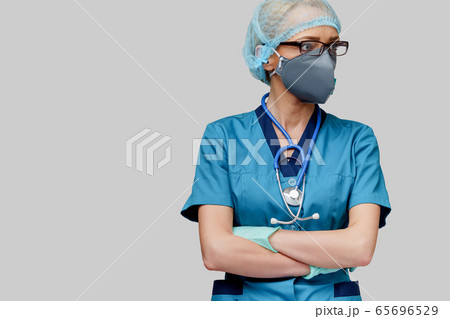 female doctor with stethoscope wearing protective mask and latex gloves over light grey background female doctor with stethoscope wearing protective mask and latex gloves over light grey background 65696529