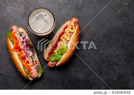 Various hot dog and glass of beer 65696846