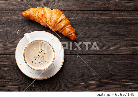 Coffee and croissants on wooden table 65697149