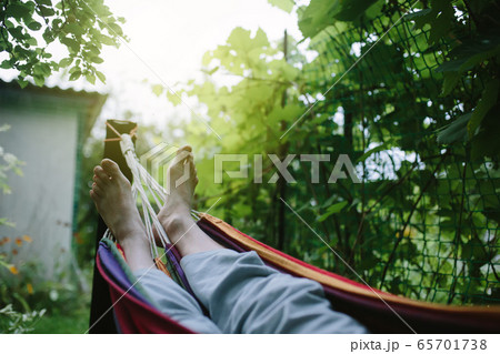 Male feet in hammock close-up, unrecognizable 65701738