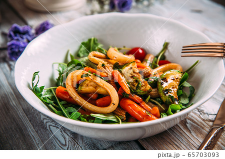 Seafood salad with vegetables and squid rings 65703093