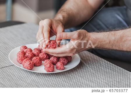 Man hands preparing meatballs with raw mincemeat 65703377