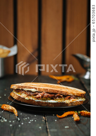 Juicy Oxtail Sandwich on a dark wooden background Juicy Oxtail Sandwich on a dark wooden background 65703683