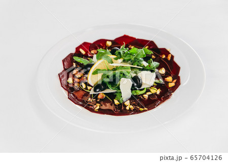 Gourmet beetroot carpaccio with cheese and herbs Gourmet beetroot carpaccio with cheese and herbs 65704126