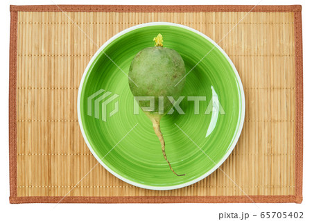 big green radish on a green plate on a cane 65705402